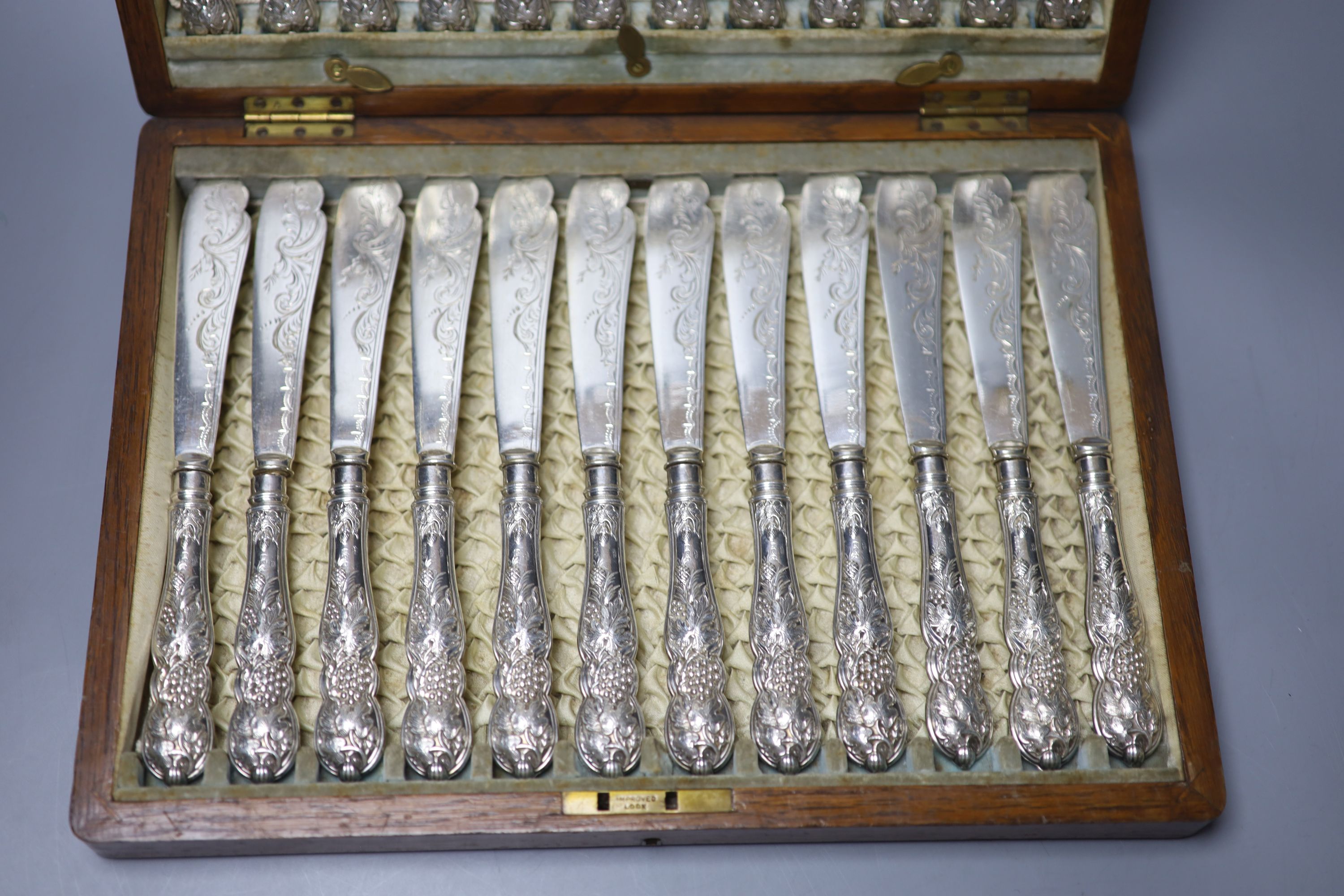 An Edwardian cased set of twelve pairs of silver handled fish eaters, John Biggin, Sheffield, 1907, case 35cm.